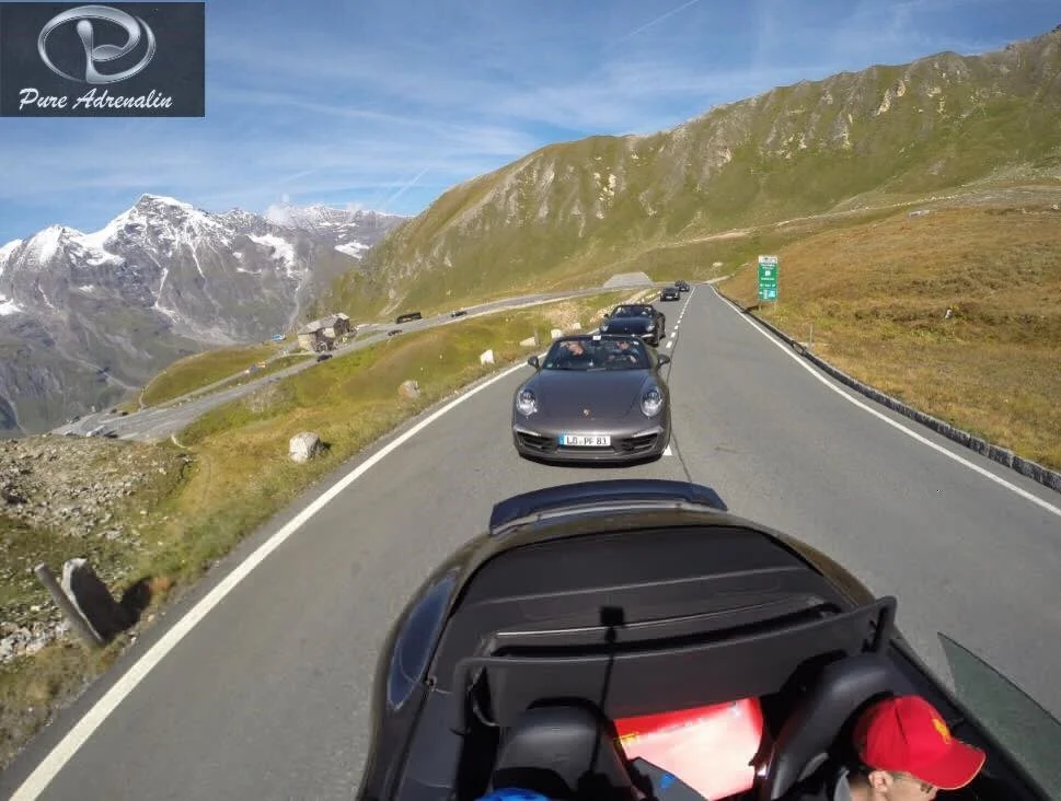 Three Porsche 911s in convoy on alpine pass