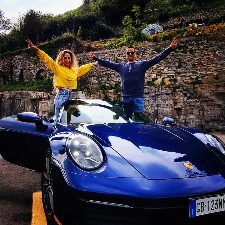 Couple posing with Porsche 911