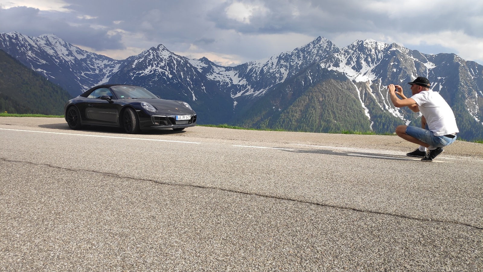 Porsche 911 in front of snowy Alps